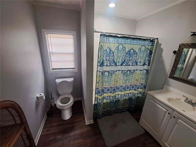 bathroom with vanity, crown molding, toilet, and wood finished floors