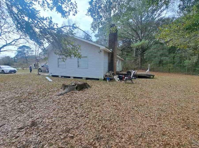 view of side of home with a chimney