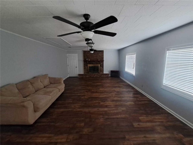 living room featuring baseboards, a fireplace, wood finished floors, a textured ceiling, and a ceiling fan