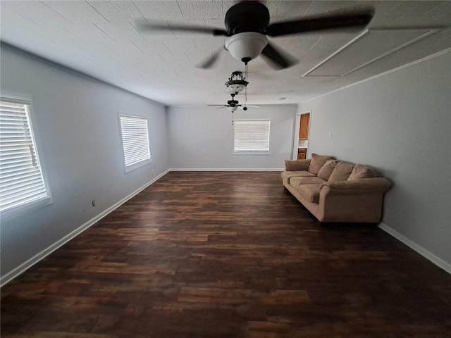 interior space with ceiling fan, a textured ceiling, baseboards, and wood finished floors