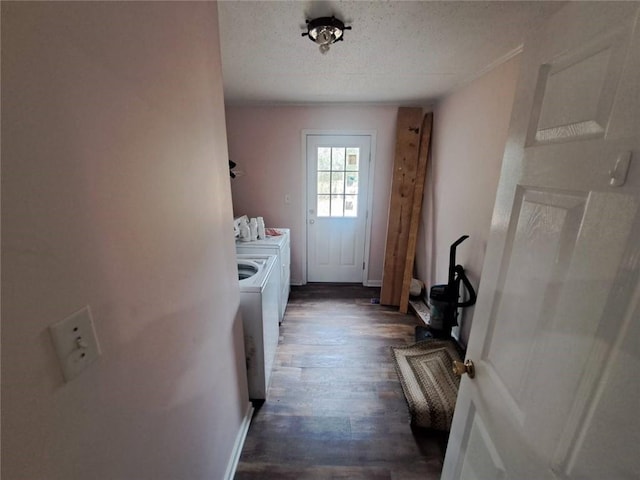 laundry area with a textured ceiling, washing machine and dryer, and dark wood-style flooring