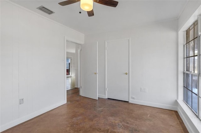 unfurnished room with plenty of natural light, ceiling fan, and ornamental molding