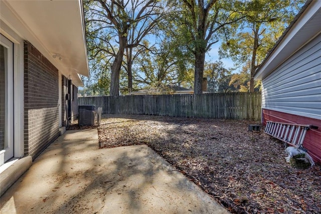 view of yard with cooling unit and a patio area