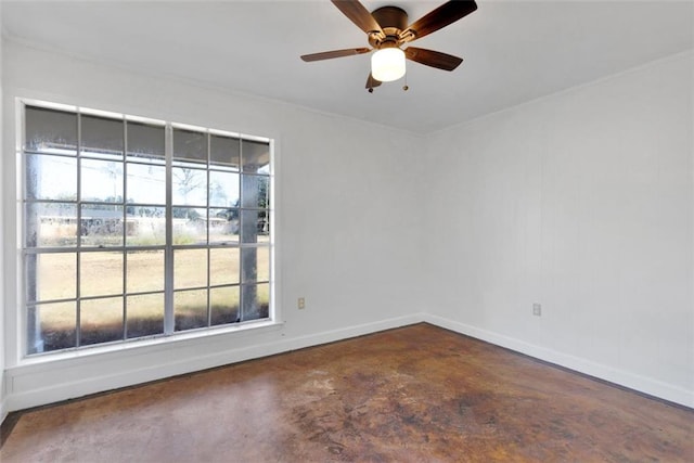 spare room with concrete floors, ceiling fan, and a healthy amount of sunlight