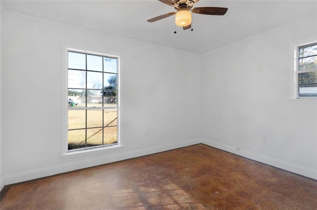 empty room featuring ceiling fan and plenty of natural light