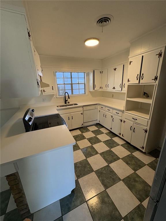 kitchen with electric range oven, sink, dishwasher, white cabinetry, and range hood