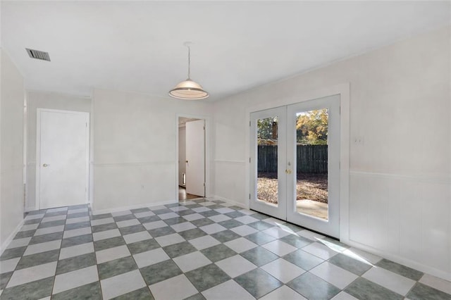 unfurnished room featuring french doors