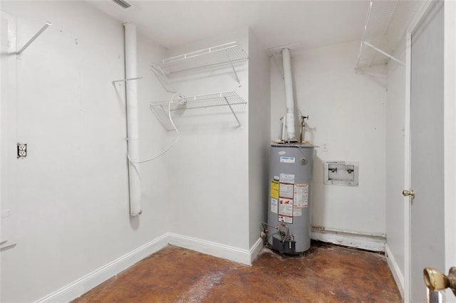 utility room featuring water heater