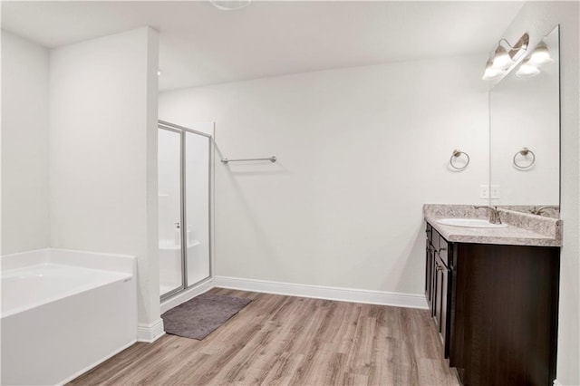 bathroom featuring vanity, independent shower and bath, and hardwood / wood-style floors