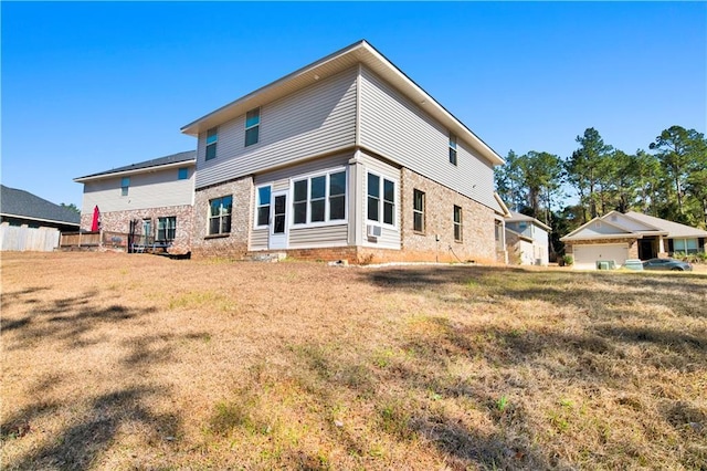 back of house featuring a yard and cooling unit