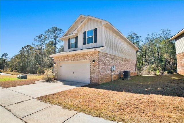 view of home's exterior featuring a garage and central AC unit