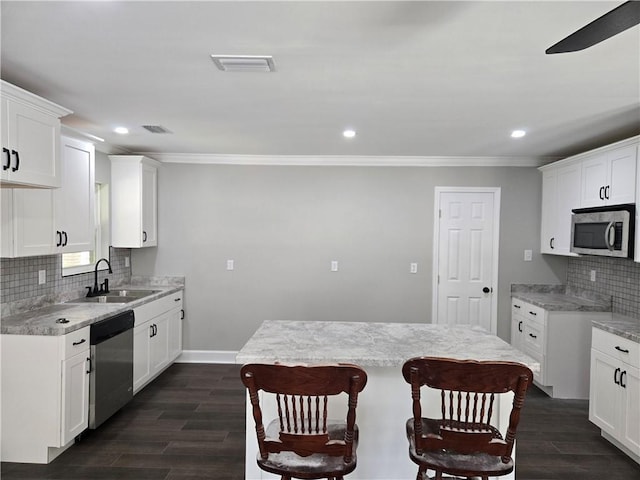 2253 Downs Ct, Mobile, AL 36617 - kitchen with crown molding, appliances with stainless steel finishes, a sink, recessed lighting, and decorative backsplash