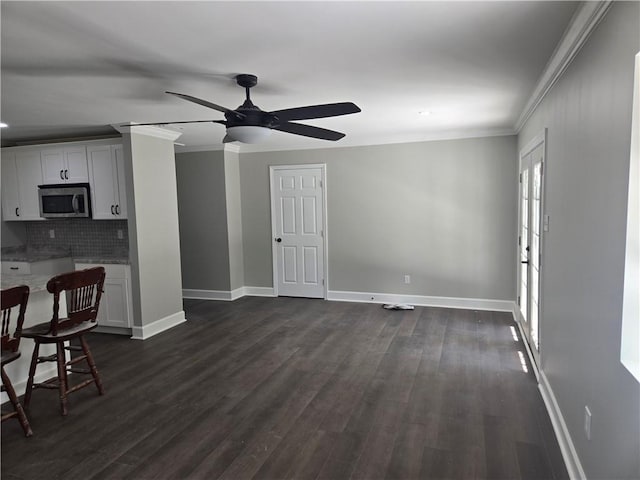 2253 Downs Ct, Mobile, AL 36617 - unfurnished living room with crown molding, baseboards, ceiling fan, and dark wood-style floors