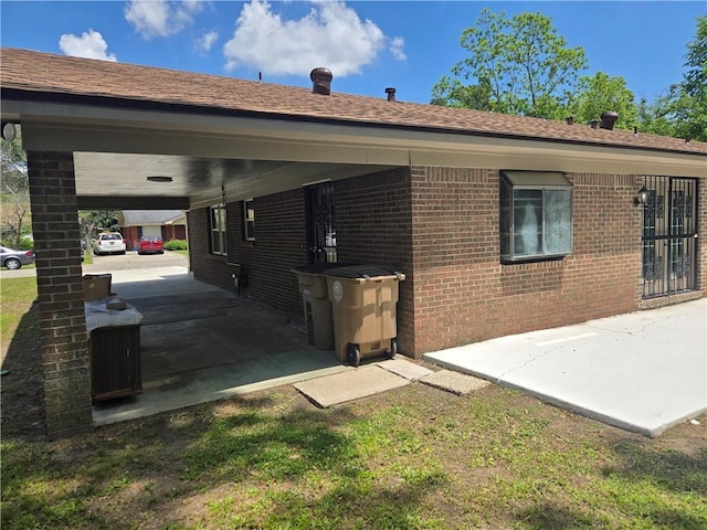 2253 Downs Ct, Mobile, AL 36617 - view of home's exterior featuring an attached carport and brick siding