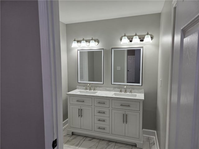 2253 Downs Ct, Mobile, AL 36617 - bathroom featuring double vanity, baseboards, a sink, and marble finish floor
