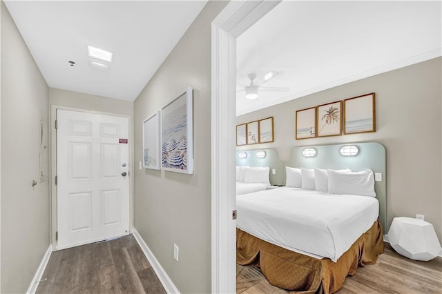 interior space featuring ceiling fan, baseboards, and wood finished floors