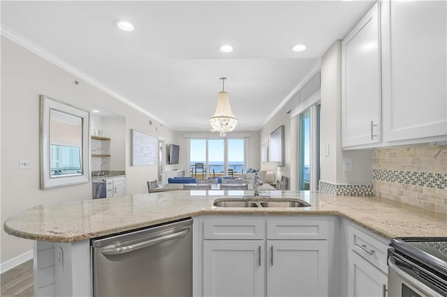 kitchen with stainless steel dishwasher, a sink, white cabinetry, a peninsula, and ornamental molding