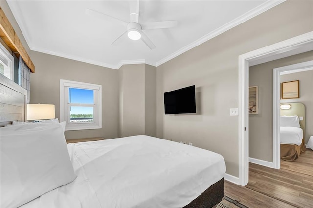 bedroom featuring ceiling fan, baseboards, crown molding, and wood finished floors