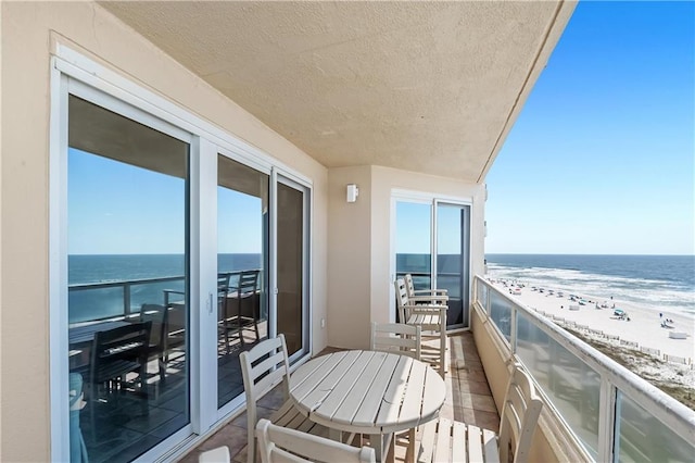 balcony with a view of the beach and a water view