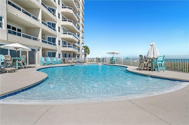 pool featuring a patio and fence