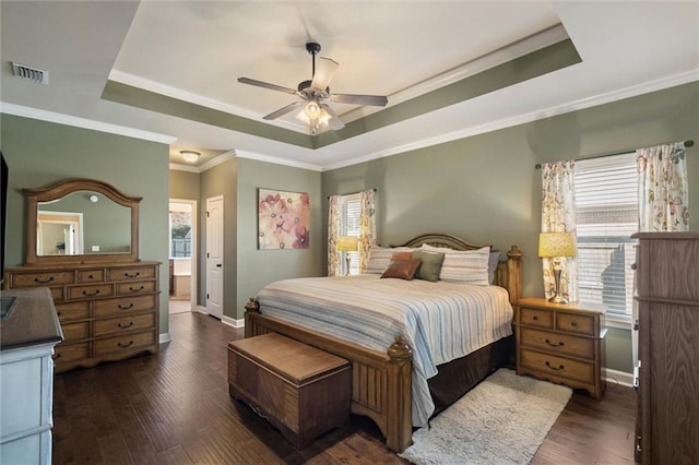 9106 Labrador Trl S, Theodore, AL 36582 - bedroom featuring visible vents, crown molding, hardwood / wood-style floors, baseboards, and a raised ceiling