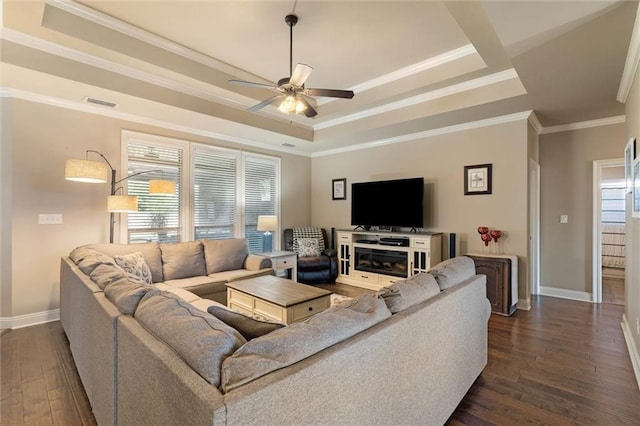 9106 Labrador Trl S, Theodore, AL 36582 - living room featuring crown molding, dark wood-style flooring, ceiling fan, a raised ceiling, and baseboards