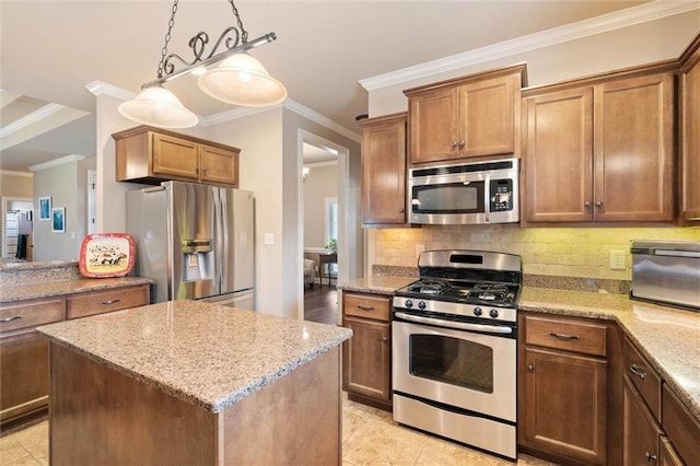 9106 Labrador Trl S, Theodore, AL 36582 - kitchen featuring ornamental molding, a center island, light stone counters, backsplash, and stainless steel appliances