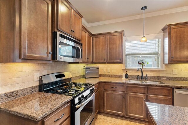 9106 Labrador Trl S, Theodore, AL 36582 - kitchen with light stone counters, a sink, stainless steel appliances, tasteful backsplash, and pendant lighting