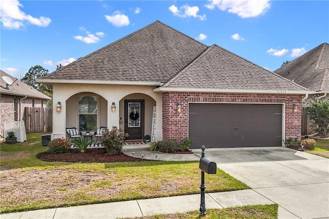 view of front of property with concrete driveway, a porch, a shingled roof, and brick siding