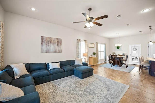 living room with baseboards, visible vents, a ceiling fan, light tile patterned flooring, and recessed lighting