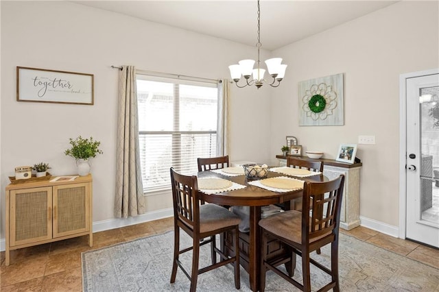 tiled dining area featuring baseboards and an inviting chandelier