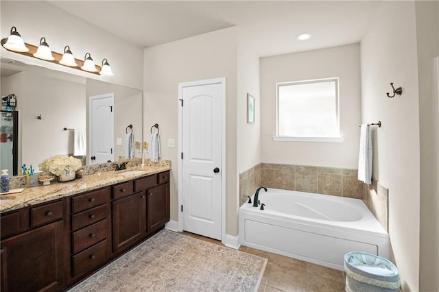 full bathroom with a bath, tile patterned flooring, double vanity, and a sink