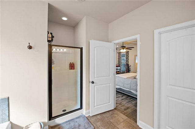 ensuite bathroom featuring a stall shower, connected bathroom, baseboards, and recessed lighting