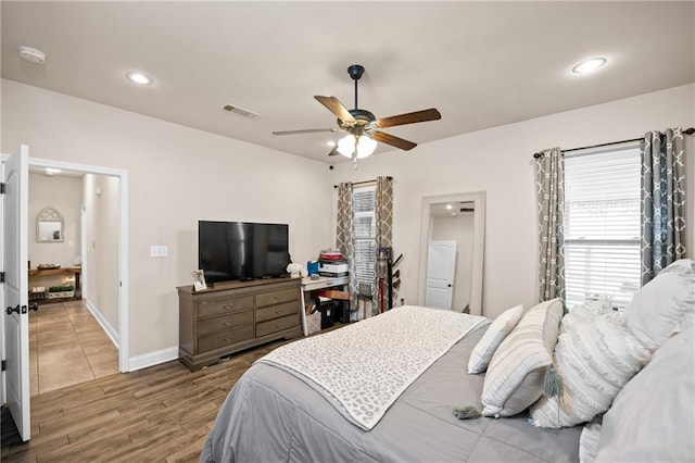 bedroom featuring recessed lighting, visible vents, ceiling fan, wood finished floors, and baseboards