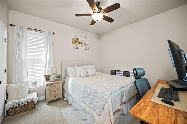 bedroom with a ceiling fan and light carpet