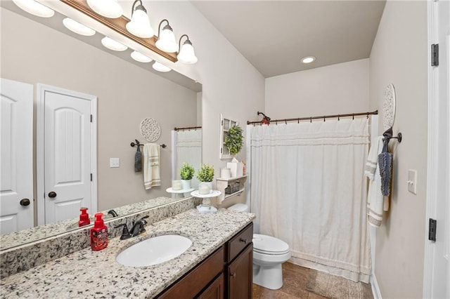 full bathroom with toilet, curtained shower, a notable chandelier, and vanity