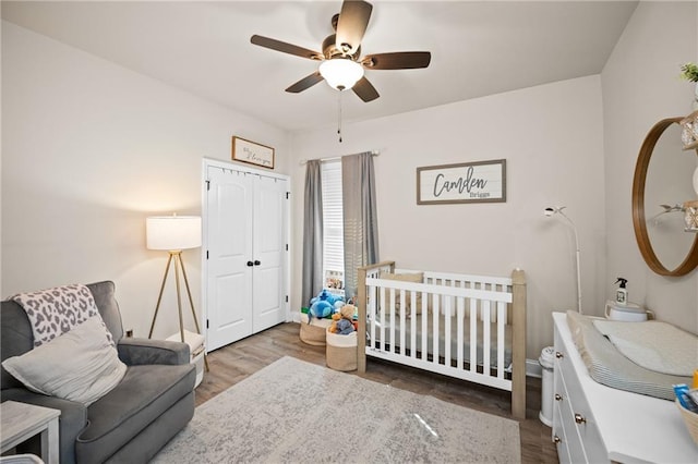 bedroom with ceiling fan, a closet, and wood finished floors