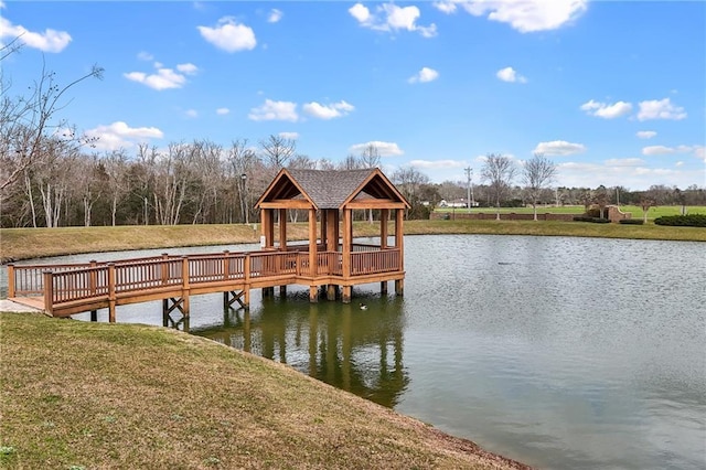 dock area with a water view, a yard, and a gazebo