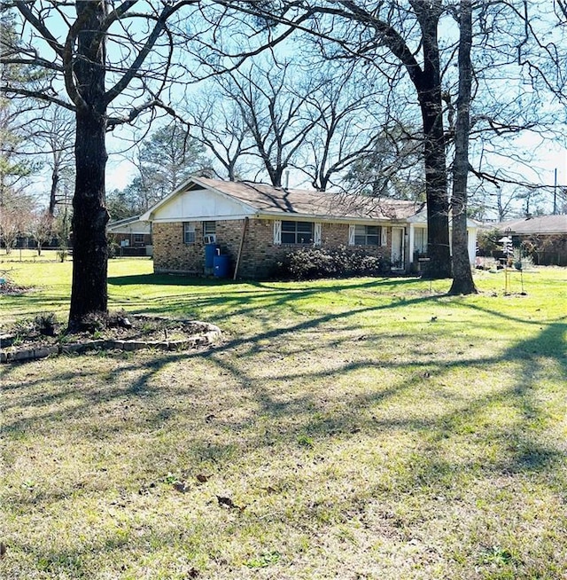 view of front of house with brick siding and a front yard