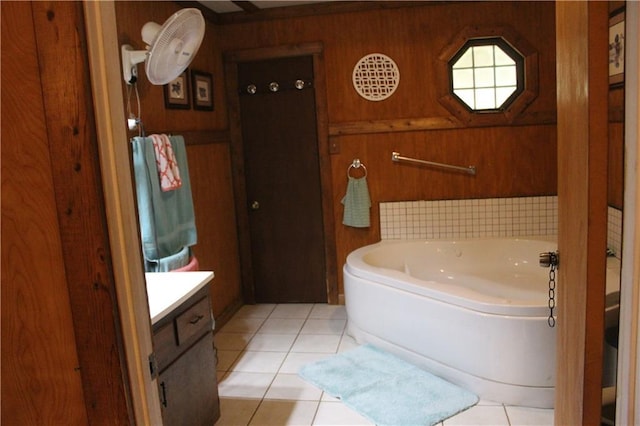 full bathroom with wooden walls, a garden tub, and tile patterned flooring