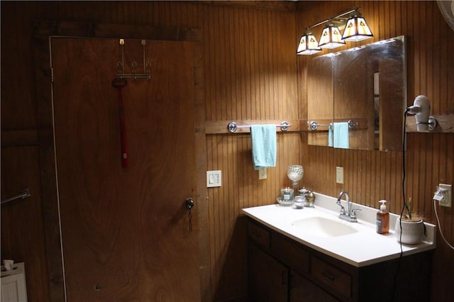 bathroom featuring wood walls and vanity