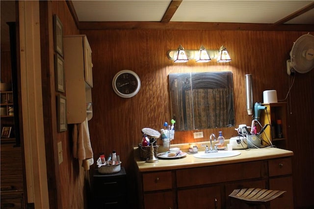 bathroom with wood walls and vanity