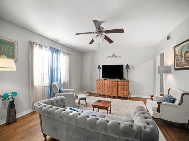 living room featuring ceiling fan and hardwood / wood-style flooring