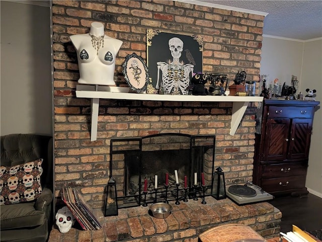 room details with a textured ceiling, ornamental molding, a brick fireplace, and hardwood / wood-style floors