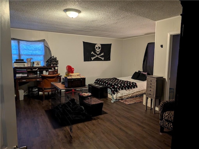 bedroom featuring a textured ceiling and dark hardwood / wood-style floors