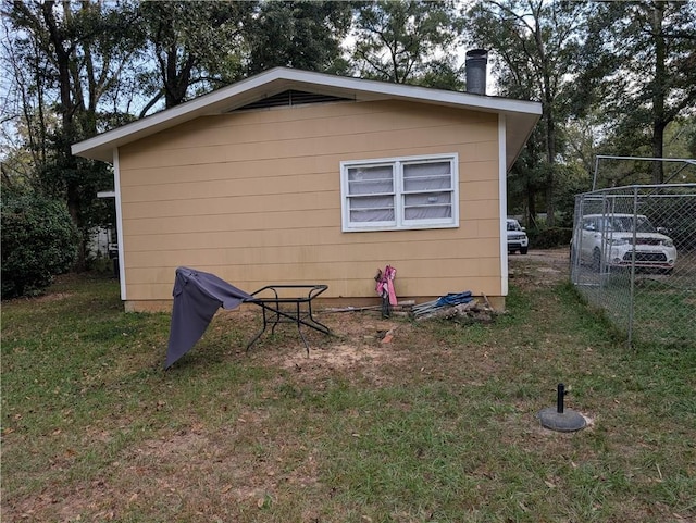 view of outbuilding featuring a yard