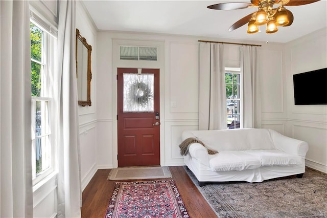 entryway featuring dark hardwood / wood-style floors, ceiling fan, and ornamental molding