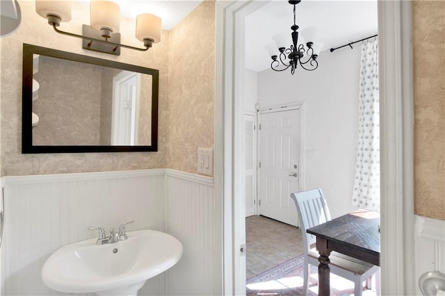 bathroom with a chandelier and sink