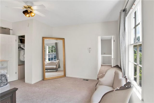 sitting room with light carpet and ceiling fan