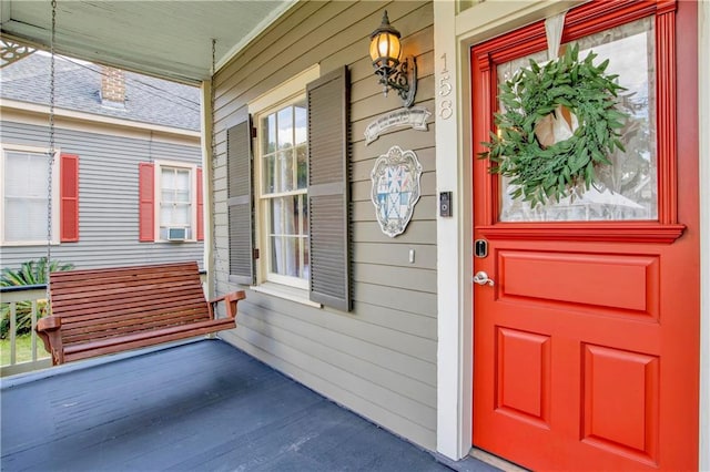 entrance to property featuring cooling unit and a porch